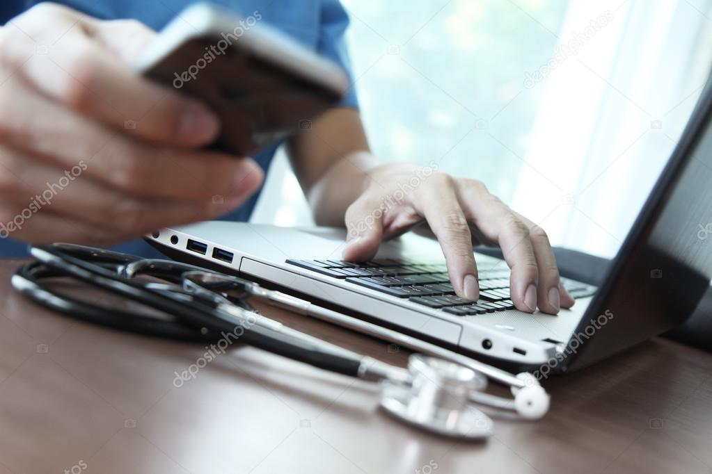 Doctor working with laptop computer in medical workspace office 