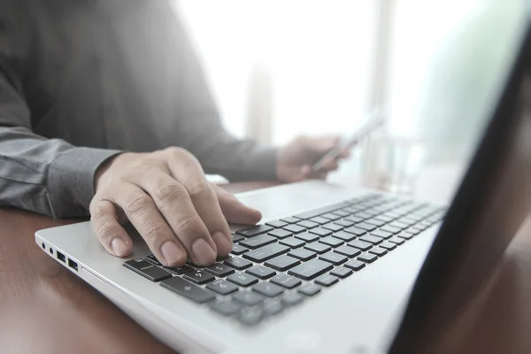 Close up of business man hand working on laptop computer with so — Stock Photo, Image