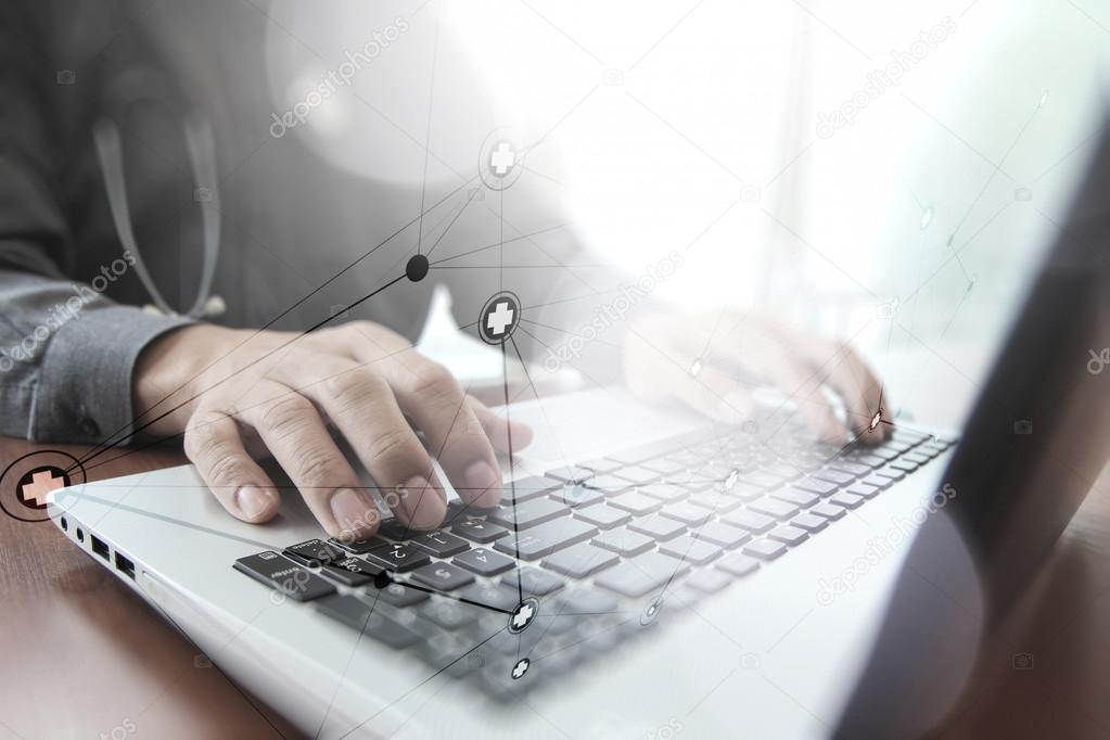 Doctor working with digital tablet and laptop computer in medica