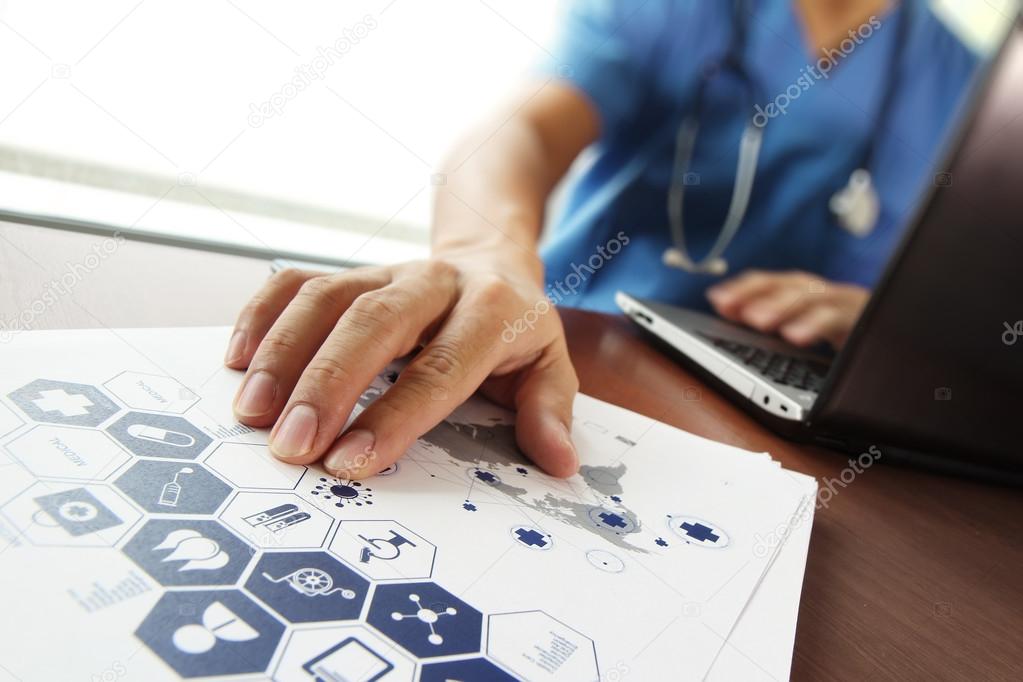 Doctor working with  laptop computer in medical workspace office