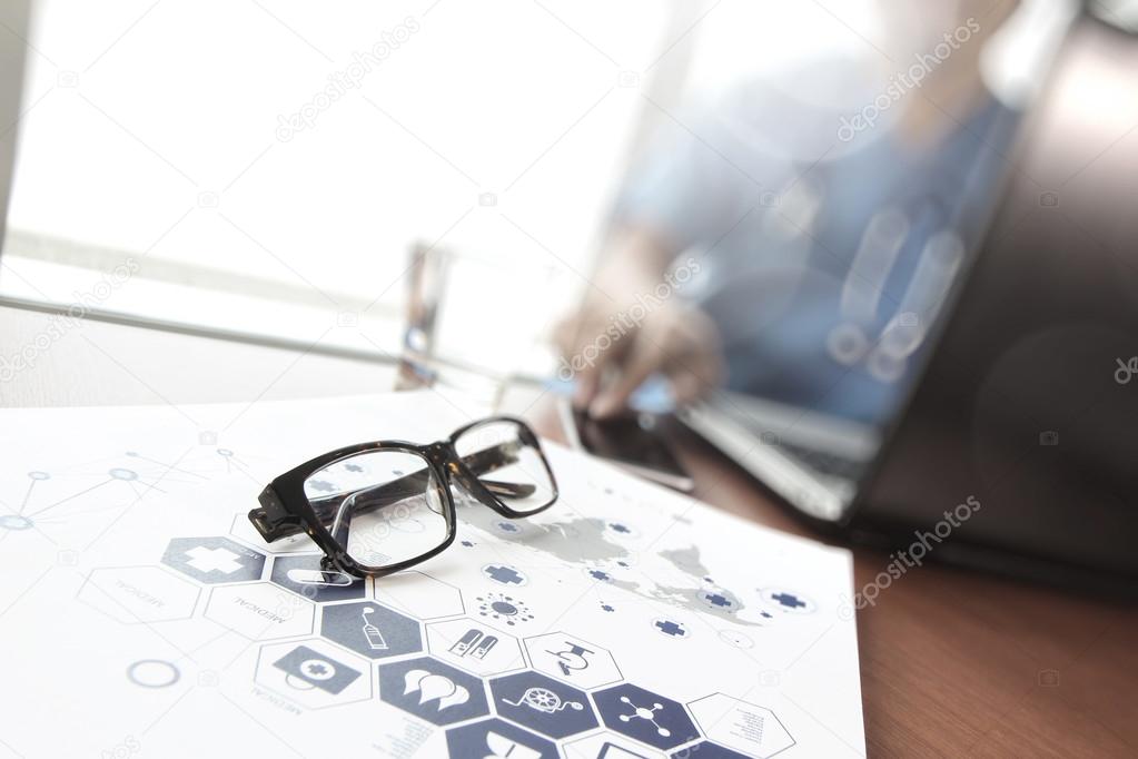 Doctor working with  laptop computer and eye glass in medical wo