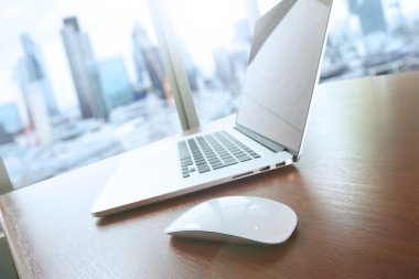 mouse and laptop computer is on wooden desk as workplace concept