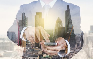 Double exposure of success businessman using smart phone with ab