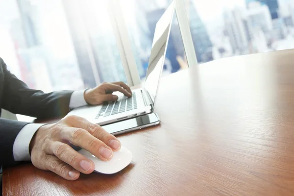 Close up of male hands on mouse and over black keyboard of lapto — Zdjęcie stockowe