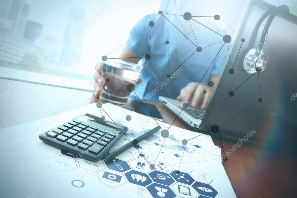 Doctor working at workspace with laptop computer in medical work