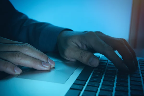 Close up of business man hand working on laptop computer with bu — Stock Photo, Image