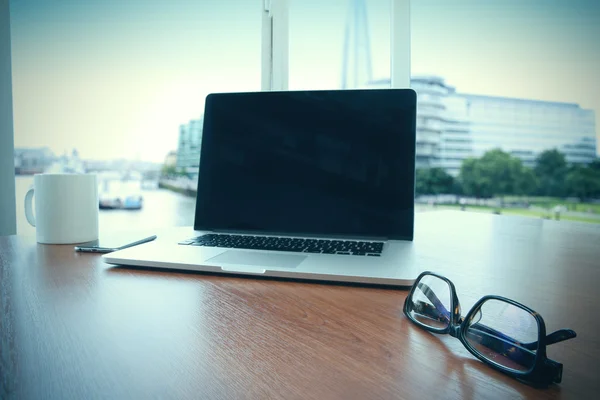 Office workplace with blank screen laptop and smart phone on woo — Stock Photo, Image