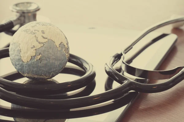 stethoscope and texture globe with digital tablet as medical net