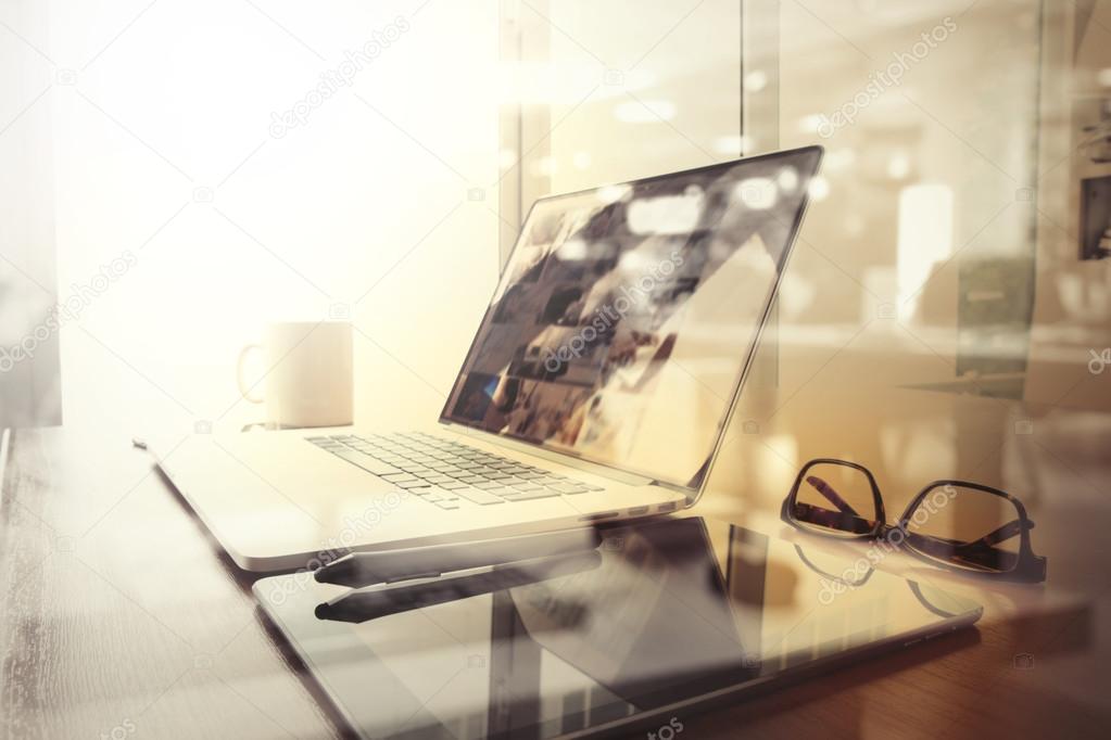 Office workplace with laptop and smart phone on wood table and l