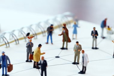 close up of miniature people with social network diagram on open clipart