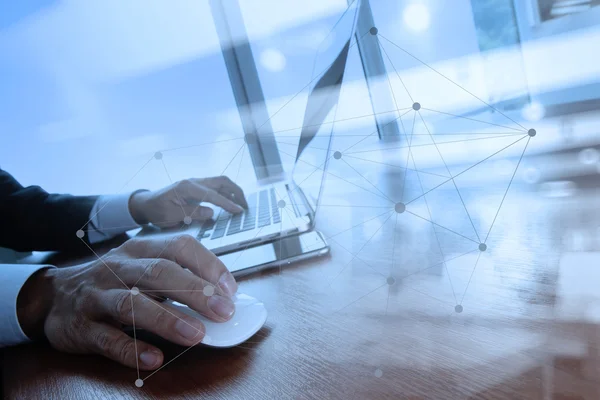 Business man hand working on laptop computer on wooden desk — Stock Photo, Image