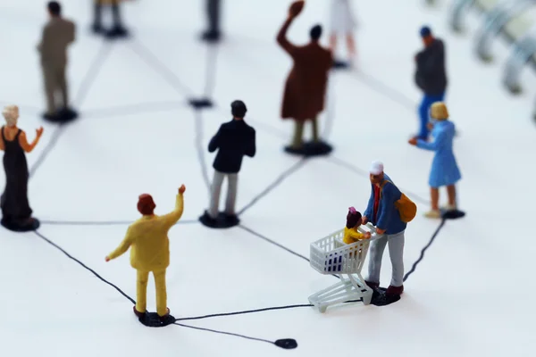 Close up of miniature people with social network diagram on open — Stock Photo, Image