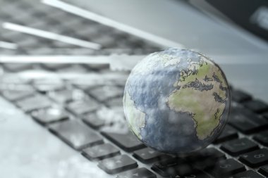 double exposurre hand drawn texture globe on laptop computer as 