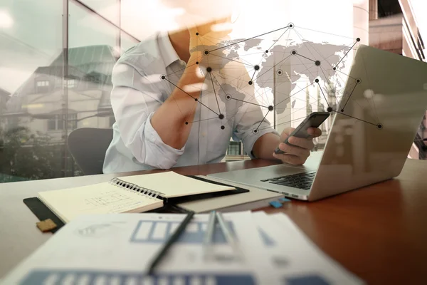 Designer hand working and smart phone and laptop on wooden desk — Stock Photo, Image