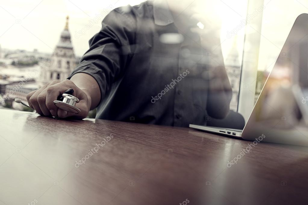 Doctor working with digital tablet and laptop computer in medica