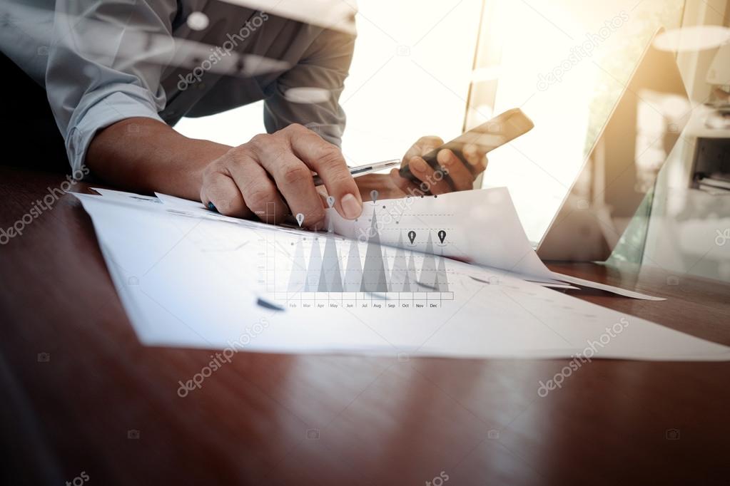 business documents on office table with smart phone and laptop c