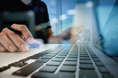 close up of hands using laptop and holding credit card as Online