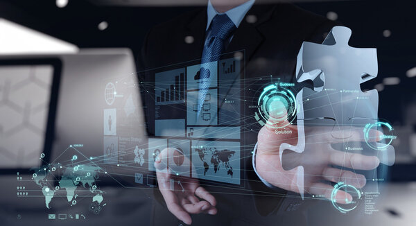 business man hand working with computer interface show puzzles
