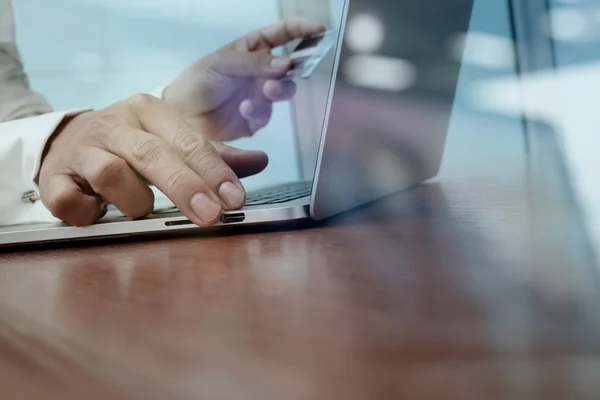 Fechar as mãos usando laptop e segurando cartão de crédito como Online — Fotografia de Stock