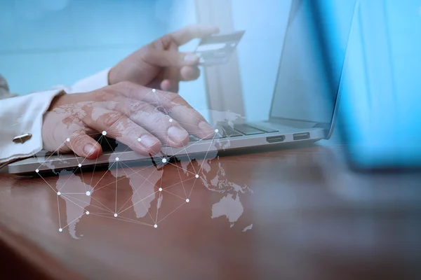 Close up of hands using laptop and holding credit card with soci — 图库照片