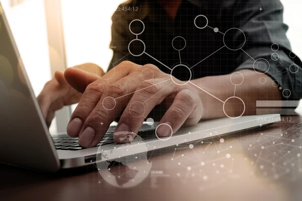 Business man hand working on laptop computer on wooden desk wit — Stockfoto