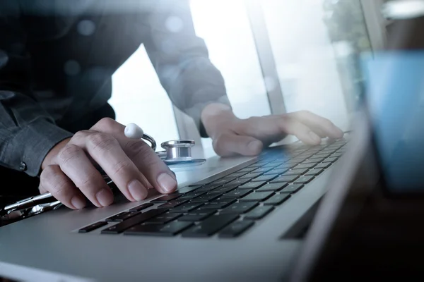 Doctor working at workspace with laptop computer in medical work — Stock Photo, Image