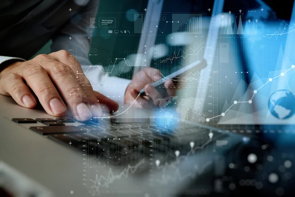 Designer hand working and smart phone and laptop on wooden desk — Stock Photo, Image