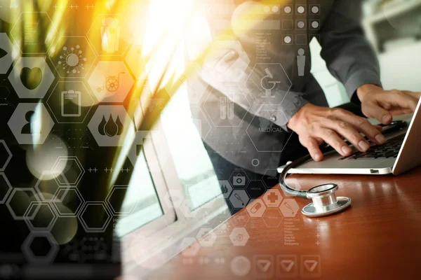 Doctor working at workspace with laptop computer in medical work — Stock Photo, Image