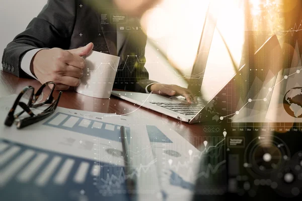 Businessman hand holding a cup of coffee with new modern compute — Stock Photo, Image