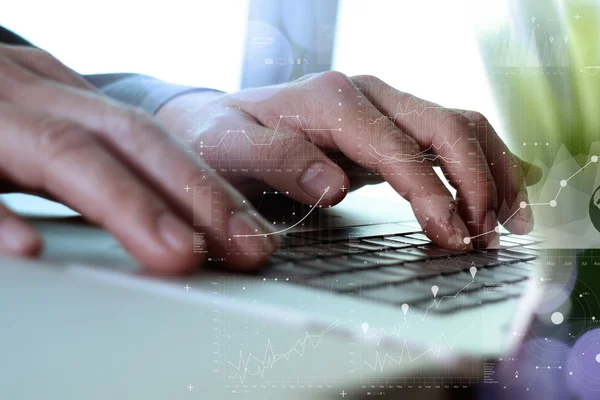 Close up of business man hand working on laptop computer with di