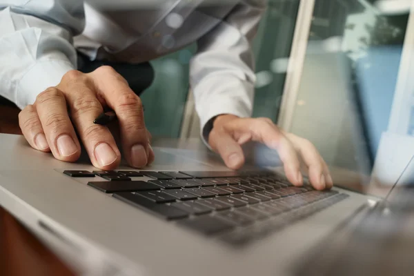 Close up of business man hand working on laptop computer with di — Stock Photo, Image