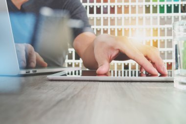 interior designer hand working with digital tablet and laptop co