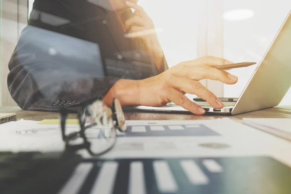 Business documents on office table with laptop computer with sma — Φωτογραφία Αρχείου