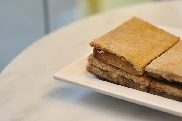 Many crispy bread on white plate — Stock Photo, Image