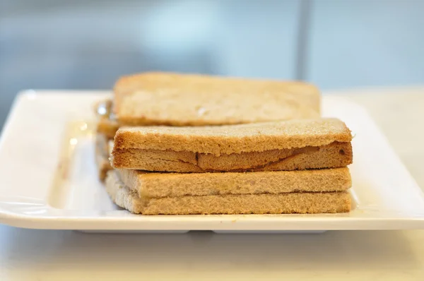 Many crispy bread on white plate — Stock Photo, Image