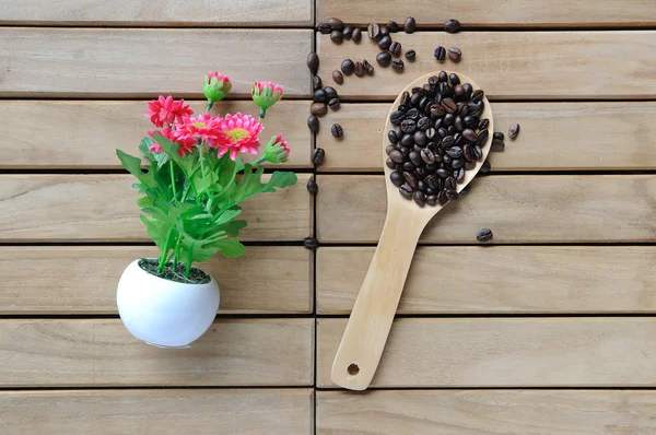 Coffee beans in wooden spoon — Stock Photo, Image