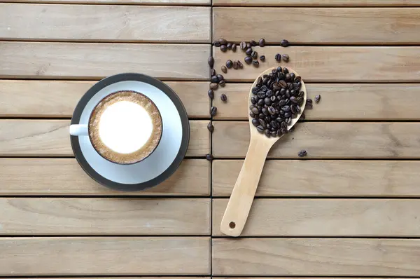 Coffee beans in wooden spoon — Stock Photo, Image