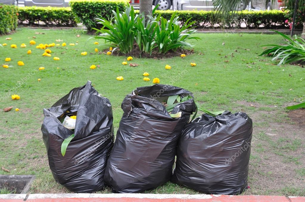 Garbage bags on green yard Stock Photo by ©ekarina 66088493