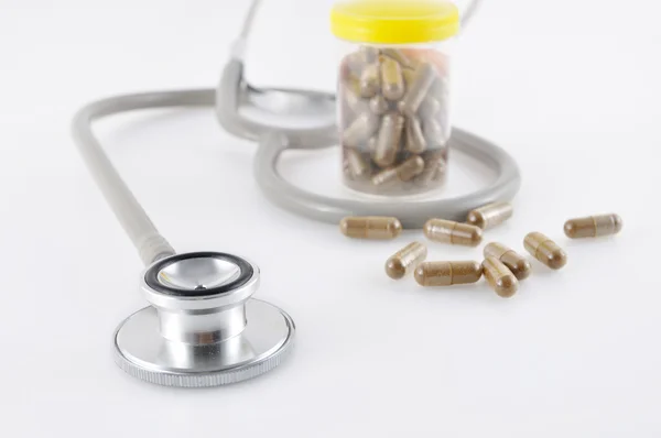 Stethoscope and bottle with pills — Stock Photo, Image