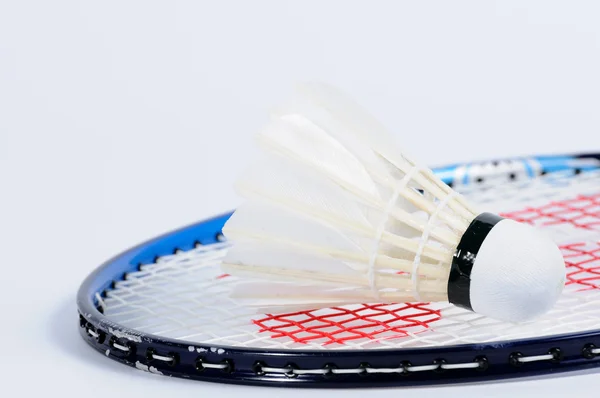 Shuttlecock lying on badminton racket. — Stock Photo, Image