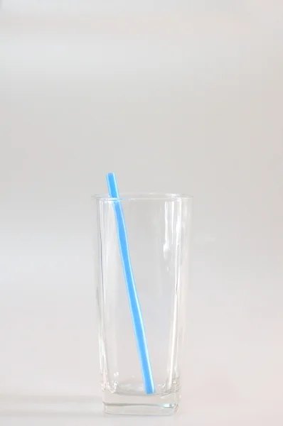 Lege glas met blauwe buis. — Stockfoto