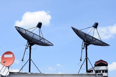 Satellite dishes on top of building clipart