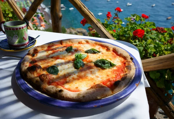 Italian pizza Margarita served on sea view terrace