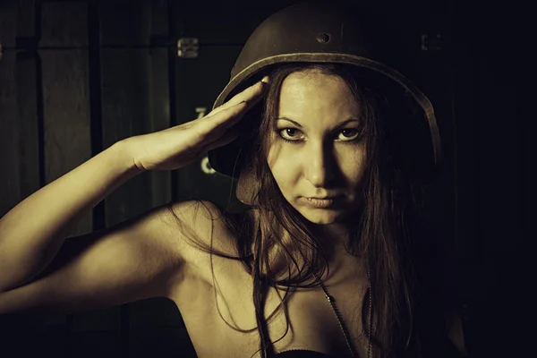 Salute of young woman in helmet — Stock Photo, Image