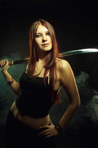 Serious girl with sword — Stock Photo, Image