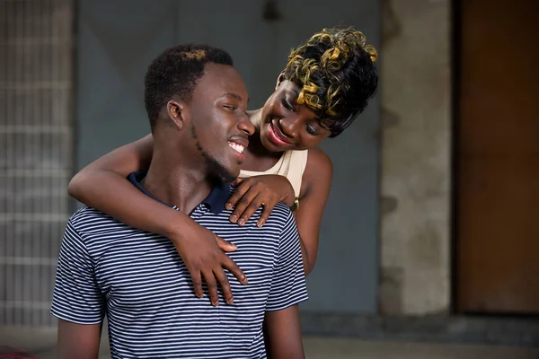 Young African Couple Standing Smiling Embracing — Stock Photo, Image