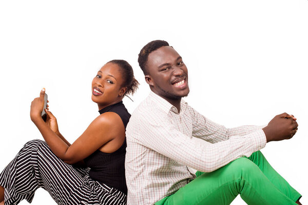 young people or happy couple sitting back handling both a laptop isolated on white background.concept communication and human relationship or love