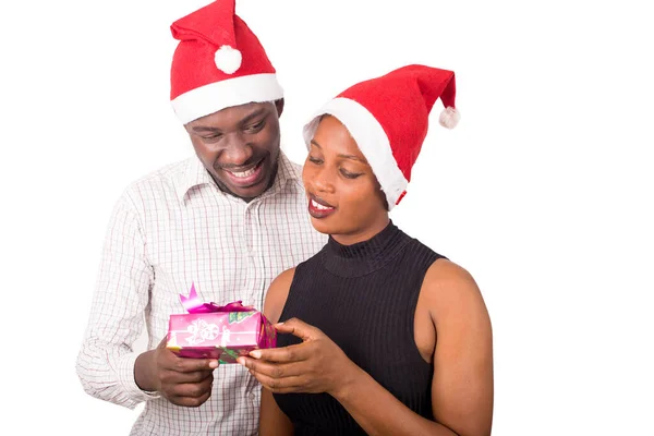 Young Couple Holding Presents Christmas Party Home Man Woman Wearing — Stock Photo, Image