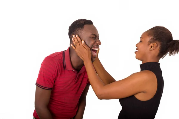 Young Couple Standing White Background Looking Each Other Laughing — Stock Photo, Image