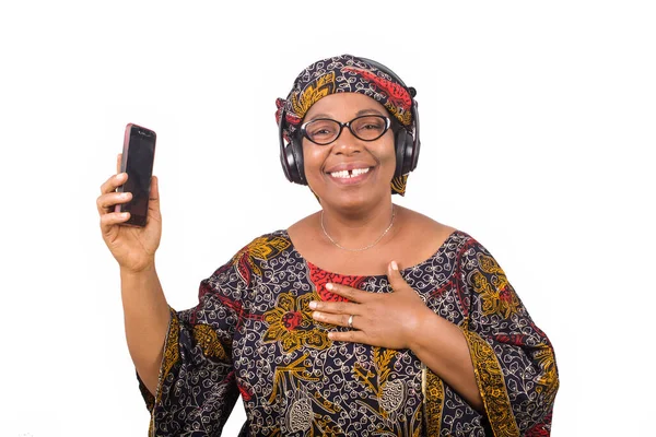 Mature African Woman Loincloth Listening Music Using Headphones Cellphone Having — Stock Photo, Image